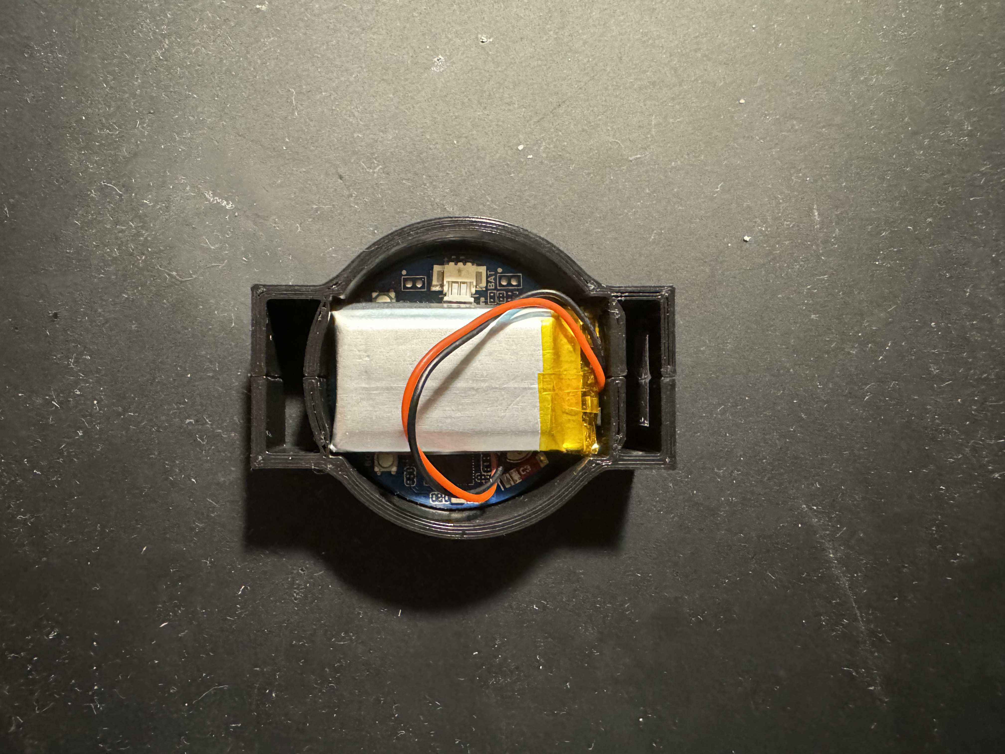 A compact sensor module designed for hand motion tracking, shown without its protective cover. The small device features a flat rectangular body with visible electronic components.