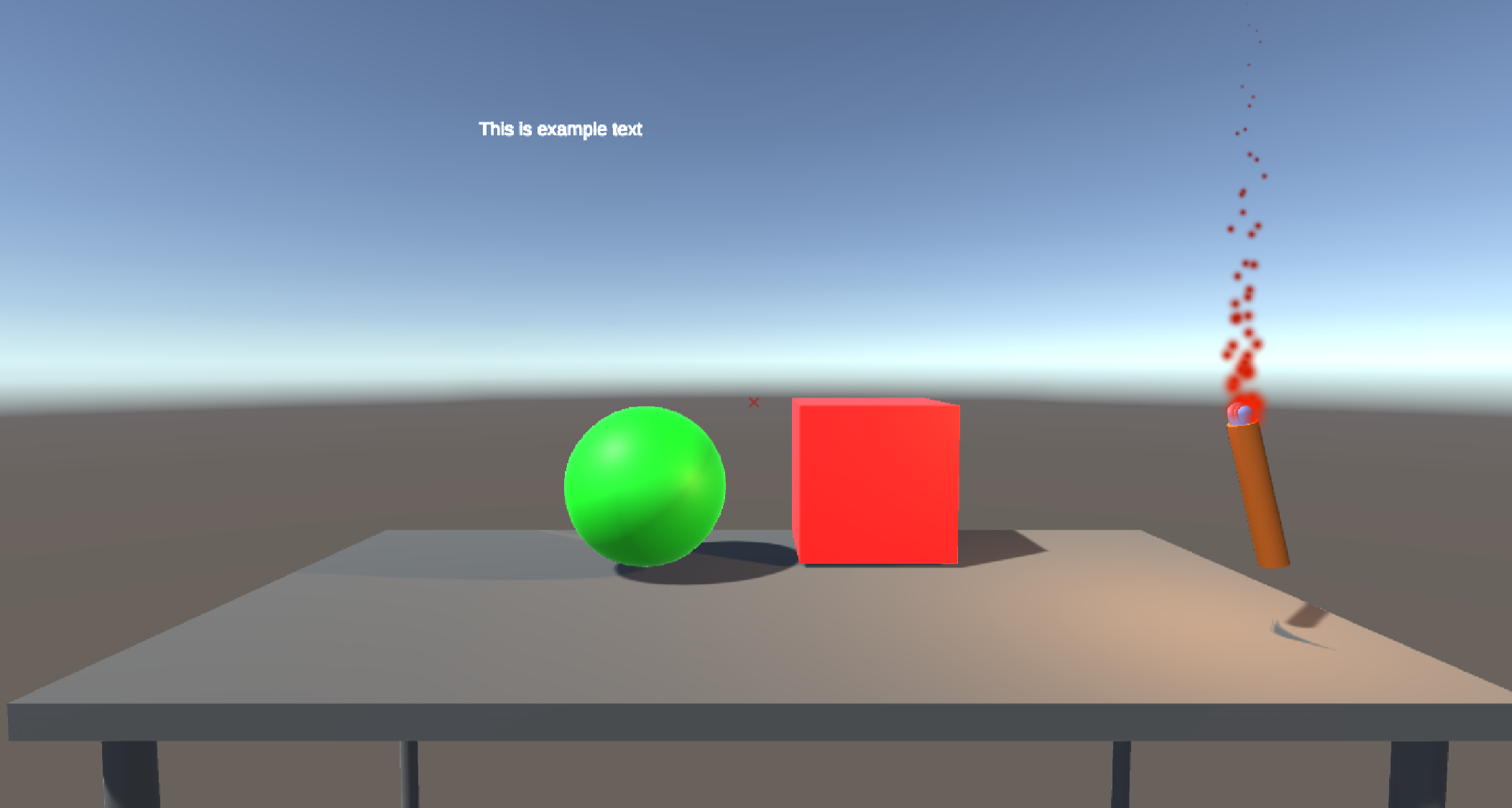 An image of a video game scene. There is a white table with a green sphere, a red cube and a burning torch on top of it. Some text is hovering over the table.