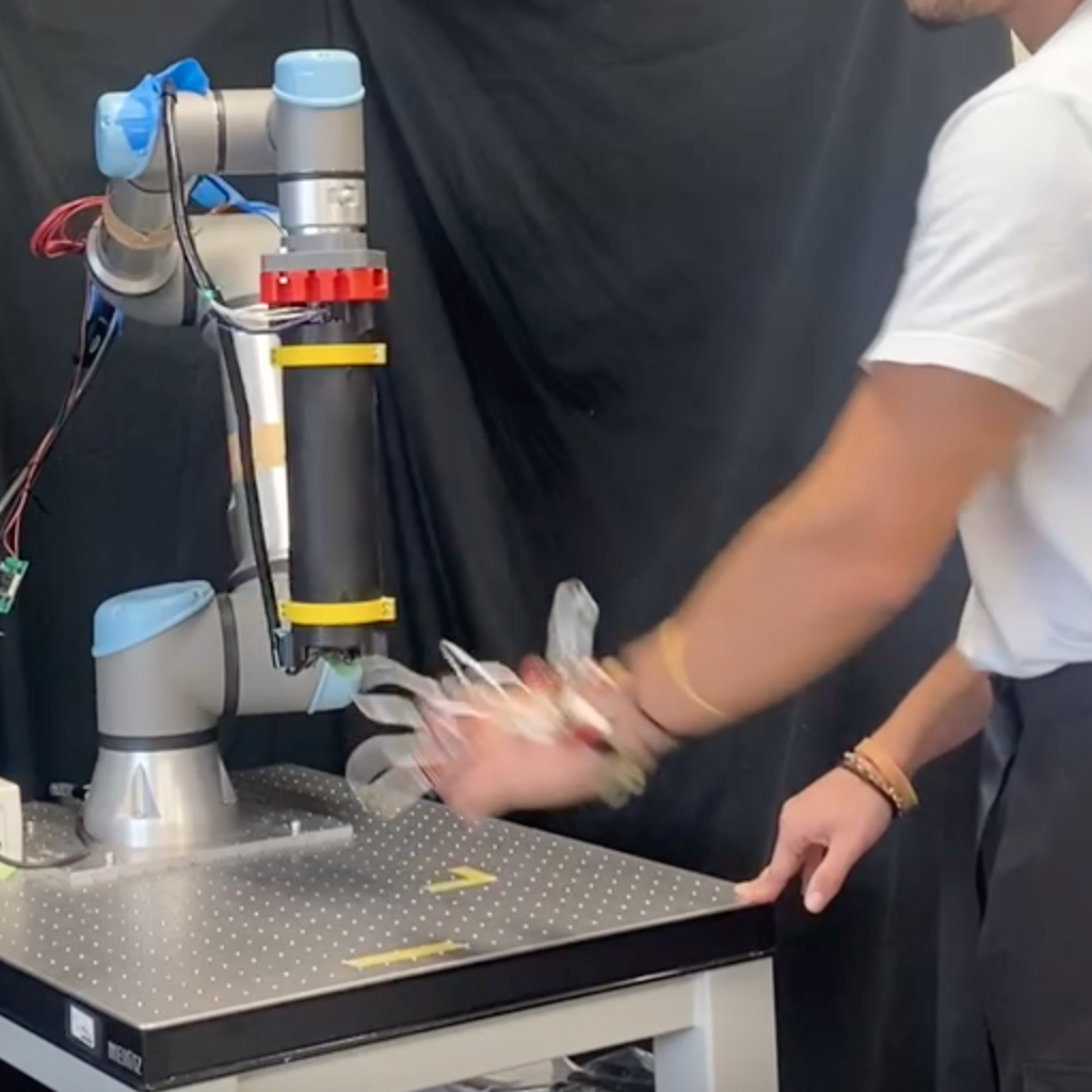 The system demonstrates a closed-loop interaction where a robot autonomously follows a designated path, responds to external cues, executes a tactile action on a device called TacLINK, and subsequently returns to a resting state upon successful action recognition - effectively establishing a cycle of movement, interaction, and confirmation.