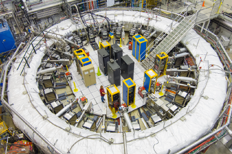 The Muon g-2 experiment at FNAL utilizes a 1.45 T magnetic field generated by three superconducting coils and four electrostatic quadrupoles to confine a muon beam within a storage ring insulated by a white blanket.