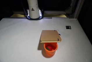 The robot successfully completed eight sequential tasks-including pushing, grasping, identifying, and rearranging objects-to reveal hidden items, demonstrating its ability to solve complex problems requiring both manipulation and visual inspection, even when objects are partially occluded or require intermediate steps like pushing an eraser to gain access.