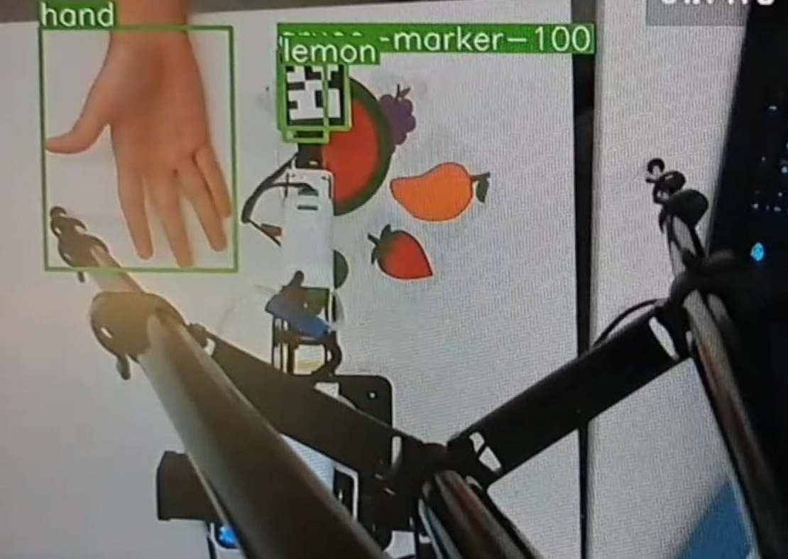 The system successfully detects both the user's hand and a lemon, enabling the robot to accurately position itself for grasping the selected object.